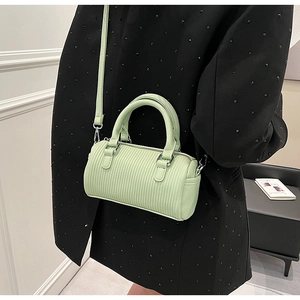Detail of mint green Boston bag with vertical pleated texture and silver hardware