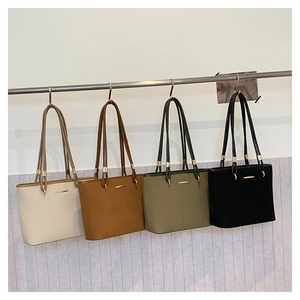 Detail view of four shoulder tote bags in white, brown, green, and black leather with metal buckles