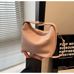 Detail view of pink pleated hobo bag with gold zipper and adjustable shoulder strap