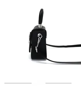 Side view of black pebble leather mini handbag with silver hardware and shoulder strap