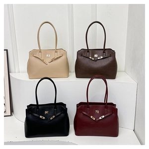 Multiple colors of minimalist chic leather tote bags with gold hardware on white display