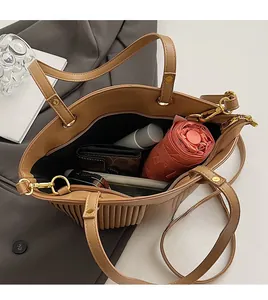 Interior view of brown tote bag showing large capacity for umbrella and wallet