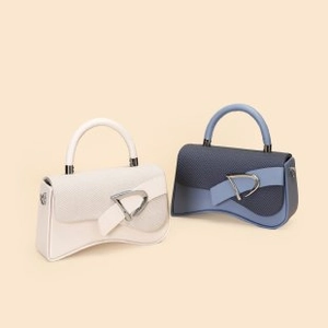 Detailed view of structured leather handbags with unique hourglass base and metal buckle