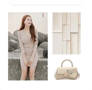 Detail of beige shoulder bag with silver D-buckle, woven texture, and curved base design
