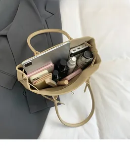Beige tote bag with spacious interior holding a tablet, phone, and daily essentials