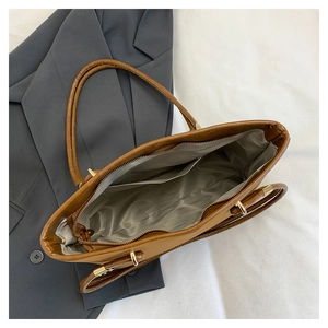 Top view of brown leather tote bag showing smooth interior lining and inner pocket