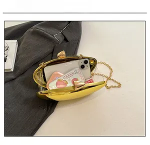 Golden oval evening clutch showing interior storage for a smartphone and chain strap