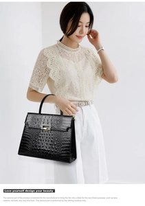 Model showcasing a black crocodile-pattern Kelly handbag with golden hardware clasp