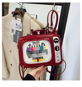 Macro shot of red retro TV crossbody bag with signal pattern and heart-shaped metal accents