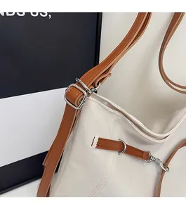 Detailed close-up of premium silver hardware and leather trim on canvas tote bag