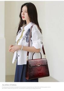 Detail of wine red crocodile pattern leather bag with gold buckle on a stylish model