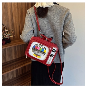 Detailed view of a red retro TV-shaped crossbody bag with No Signal screen design