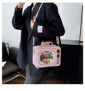 Detail of pink retro TV crossbody bag featuring clear window and No Signal pattern