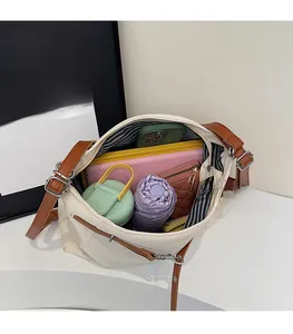 Top view of the spacious canvas tote bag interior filled with daily essentials and leather straps