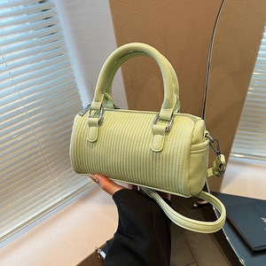 Light green pleated leather Boston bag with top handles and adjustable shoulder strap