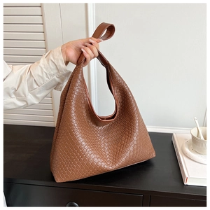 Close-up of brown woven texture and premium craftsmanship on this stylish hobo tote bag