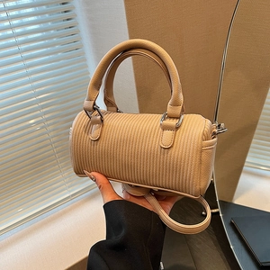 Beige quilted barrel handbag with ripple texture and detachable shoulder strap for women