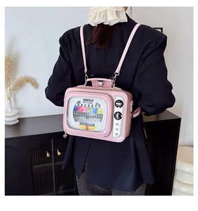 Detail of a pink vintage TV backpack with a transparent screen on a model in a retro setting