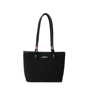 Minimalist black tote bag with matte finish and gold hardware accents on white background