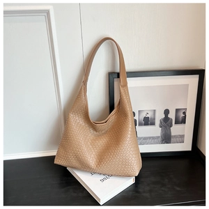 Detail of camel woven hobo bag showing intricate texture and smooth shoulder strap
