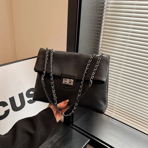 Chic black corduroy tote bag with silver chain strap and metal lock closure