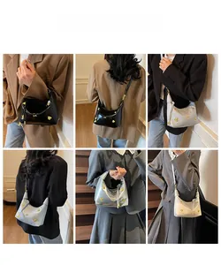 Three-color leather hobo bags with golden bear charms shown on models in indoor settings