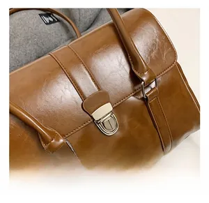 Close-up of the vintage brown leather bag featuring a gold-toned twist lock closure