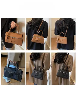 Detail showing woven texture and multiple carrying styles of the minimalist square bag