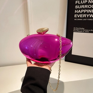 Fuchsia metallic hard-shell clutch with gold pebble lock and acrylic chain strap