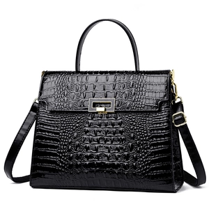 Glossy black crocodile pattern Kelly handbag with gold lock and adjustable shoulder strap