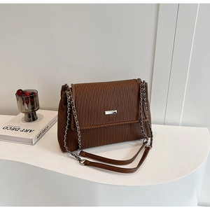 Detailed view of dark brown pleated leather shoulder bag with silver chain strap