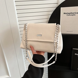Cream white corduroy crossbody bag with silver chain strap and minimalist metal bar accent