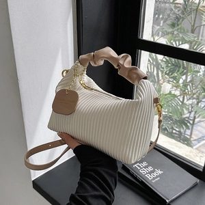 Chic pleated cream handbag with contrast brown handle and gold chain detail
