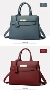 Detail of blue and burgundy leather tote bags with pebble grain texture and gold buckles