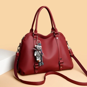 Burgundy lychee grain leather shell bag with bear charm and adjustable shoulder strap