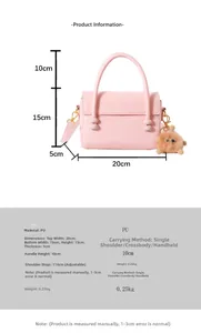 Size chart showing pink PU leather handbag dimensions with fur ball pendant details