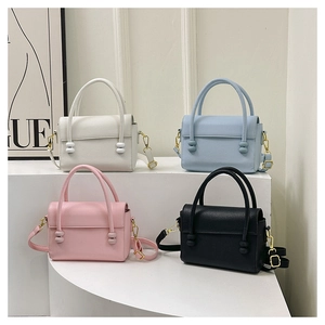 Litchi pattern handbags in ivory, blue, pink, and black colors on display steps