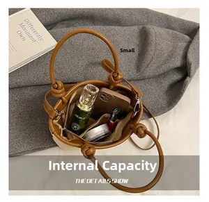 Detail show of spacious bucket bag interior with khaki weave and brown leather trim