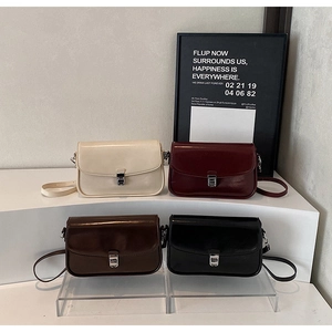 Chic underarm bags in cream, burgundy, caramel, and black with silver buckles