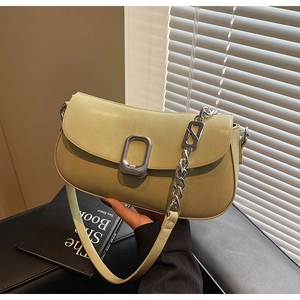 Detail of avocado green leather shoulder bag with silver buckle and metal chain strap