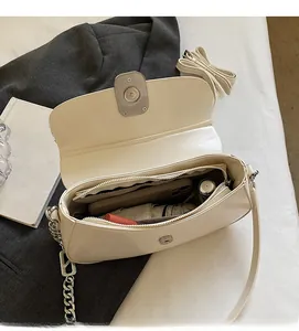 Interior view showing large capacity space of cream leather saddle bag with daily items