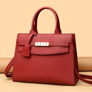 Classic red leather trapezoid handbag with gold rotating lock and top handle
