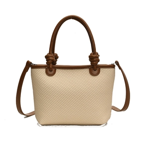 Straw basket tote with brown leather trim, dual handles and adjustable shoulder strap