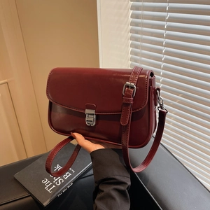 Elegant wine red patent leather shoulder bag with silver clasp and adjustable strap