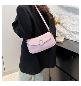 Detail of pink baguette underarm bag featuring a metallic silver buckle and smooth PU leather
