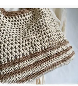 Close-up of bohemian hollow weave pattern on two-tone woven bucket tote bag