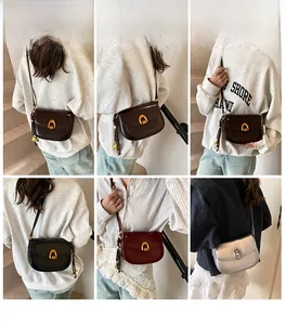 Detail of classic saddle bags showing metal horseshoe buckles and leather textures