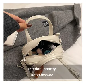Internal capacity of beige patent leather bowling bag with cosmetics and lipstick