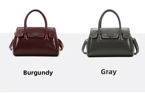 Detail view of burgundy and grey handbags with woven handles and metal twist locks
