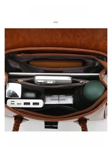 Detailed interior view of a brown leather shoulder bag with multi-compartment storage